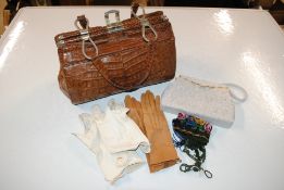 An Exotic skin handbag; a beadwork decorated evening bag and beadwork decorated purse and gloves