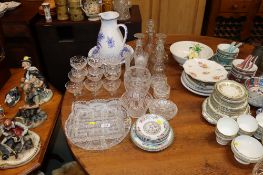A collection of various glassware to include triple ring necked decanters, drinking glasses, blue