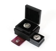 A 2013 Britannia silver proof £5 coin and another 'Harry and Megan' 2018 silver proof £5 coin