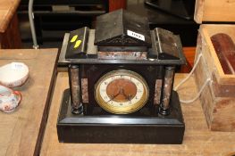 A black slate two-hole mantel clock