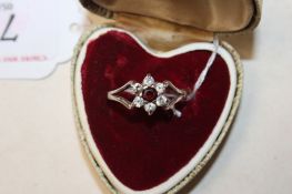 A 925 silver ring set with garnet and white stones