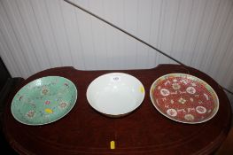 An Oriental famille rose plate with character marks to base; and one other similar plate and bowl,