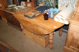 A stripped pine drop leaf dining table