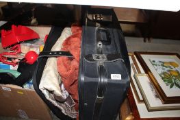 A suitcase containing various fabric