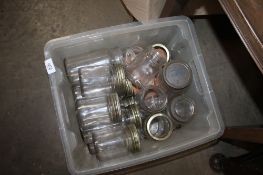 A box containing various Kilner and glass storage jars