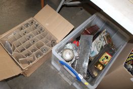 Two boxes containing various glassware; advertising tins; money banks etc.