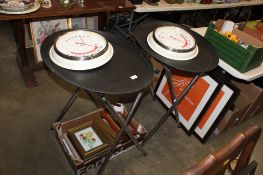 Four Beefeater coloured prints; two decorative wall clocks and a pair of plastic trays on stands