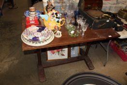 An oak pub table raised on stretcher base