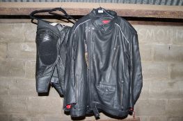 A Triumph motorcycle leather jacket size large and a pair of Dainese black leather motorcycle