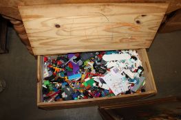A wooden crate containing various Lego