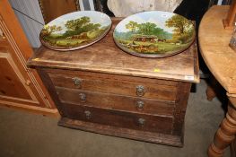 An oak chest fitted three drawers having lion mask handles