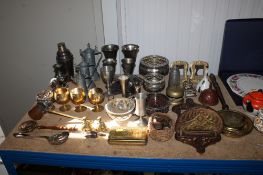 A collection of various metalware to include a silver plated cocktail shaker, brass picture
