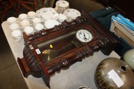 A two-hole cased wall clock