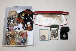 A box containing various costume jewellery, dress rings, brooches, etc.