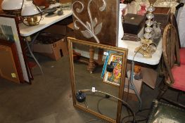 A gilt framed wall mirror and an abstract print