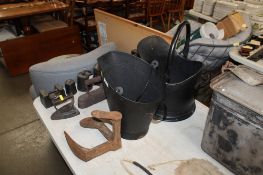 Two coal scuttles and an anchor