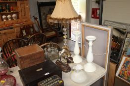 A brass and glass table lamp; silver plated cruet set; a wooden wall light and a pair of candle