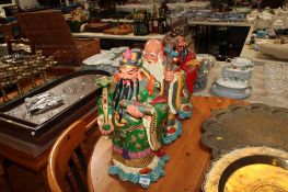 Three oriental figures