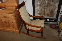A mahogany framed and floral upholstered rocking chair