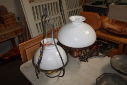 Two hanging oil lamps with opaque shades