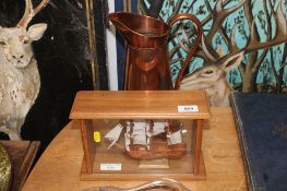 A wooden cased model boat 'Belle Mare Plage' together with a copper jug