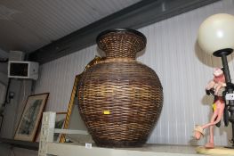 A wicker cased Studio Pottery vase