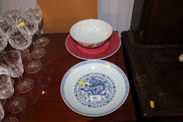 An Oriental blue and white plate decorated with a dragon having character marks to base; an Oriental