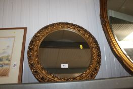 A gilt framed circular wall mirror
