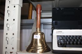 A brass hand bell (73)