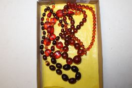 Three amber coloured bead necklaces