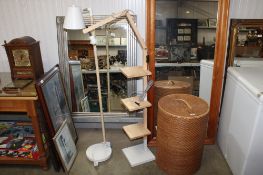 A modern wooden standard lamp fitted with three shelves