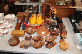 A quantity of various wooden ware to include a pair of clogs, boot scrapers, face masks etc.