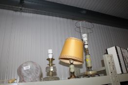 Two onyx style table lamps; a glass table lamp; and a glass shade