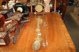 A brass gong; various horse brasses and three brass fire irons