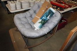 A metal framed garden rocking chair