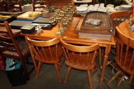 A modern wood effect table together with a set of four chairs