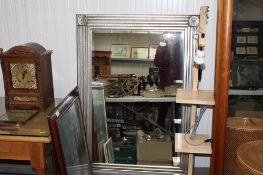 A modern framed and bevel edged wall mirror