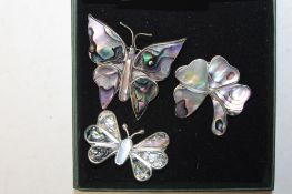 Three mother of pearl brooches