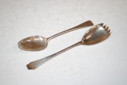 A silver spoon engraved 'Joyce From Her Godfather' and a silver salad serving spoon, 147.5gms