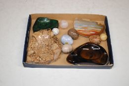 A tigers eye ash tray, banded agate, malachite, and polished stone eggs
