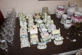 A collection of various Coalport pastel burner and other cottages, some AF