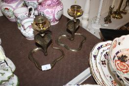 A pair of Indian brass cobra candlesticks