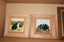 Two framed tiles decorated with pigs