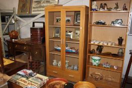 A modern oak effect display cabinet fitted two drawers