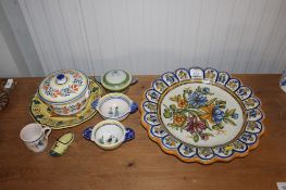 A quantity of H. Quimper pottery to include floral decorated charger, bowls etc.