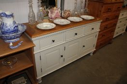 A modern oak topped sideboard fitted three drawers
