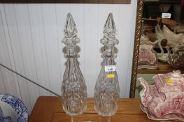 A pair of cut glass decanters and stoppers