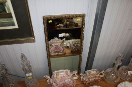 A gilt framed oblong wall mirror