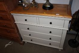 A modern oak topped chest fitted two short over three long drawers