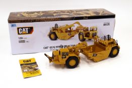 A DieCast Masters 1:50 CAT 657G Wheel Tractor-Scraper 85175 with metal box. (3)
